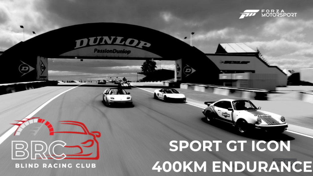 image contains a group of race cars going beneath a bridge with large lettering on the bridge that says, dunlop